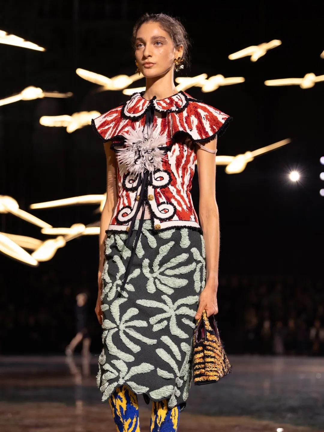 A full view of a Chanel S/S 2027 piece displaying chromatic pattern play and juxtaposed textile techniques