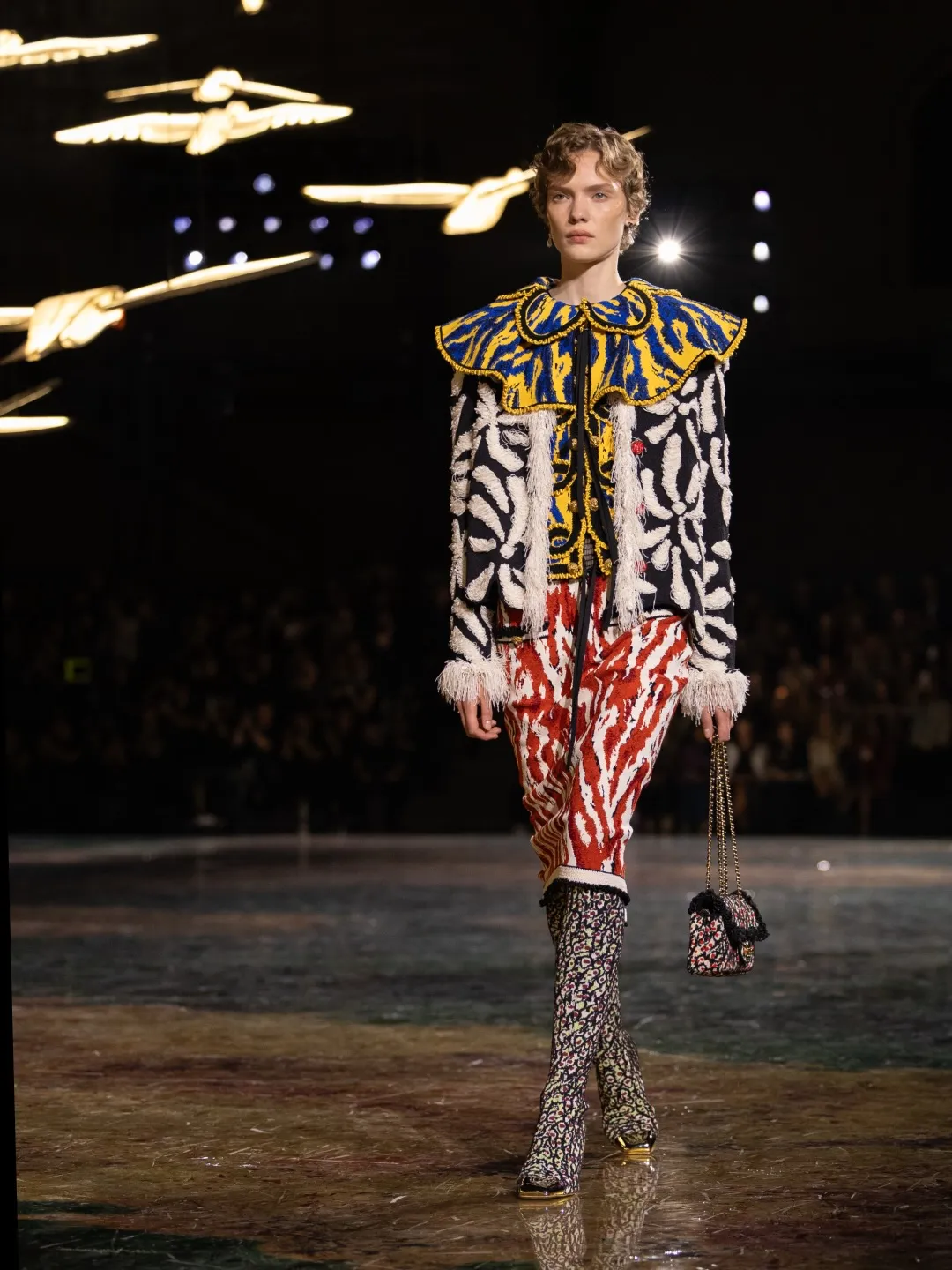 Model wearing intricate embroidered Chanel design featuring the house's signature animal print in vivid colourway