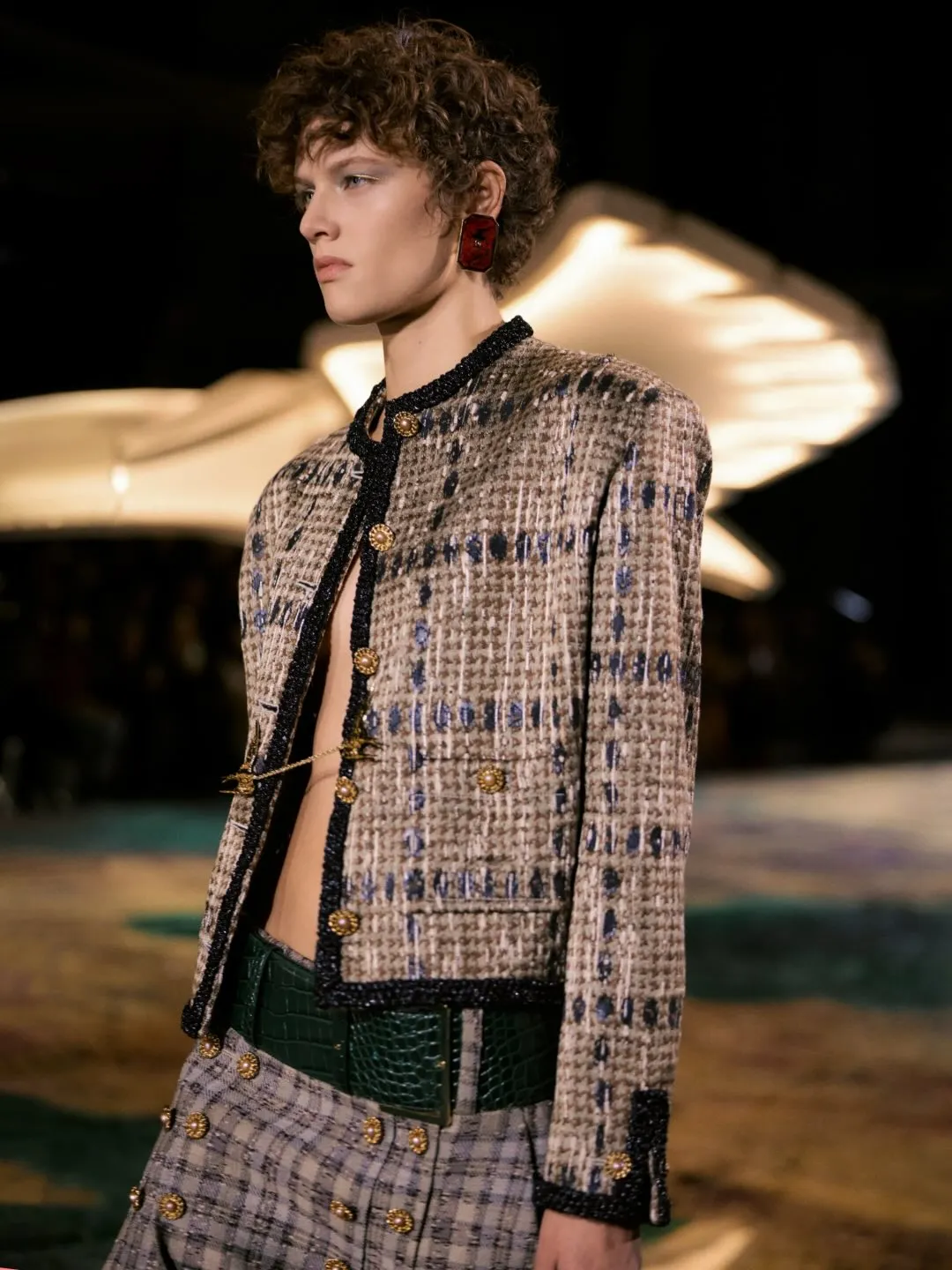 Deconstructed menswear-inspired jacket detail showing unbuttoned silhouette and architectural tailoring