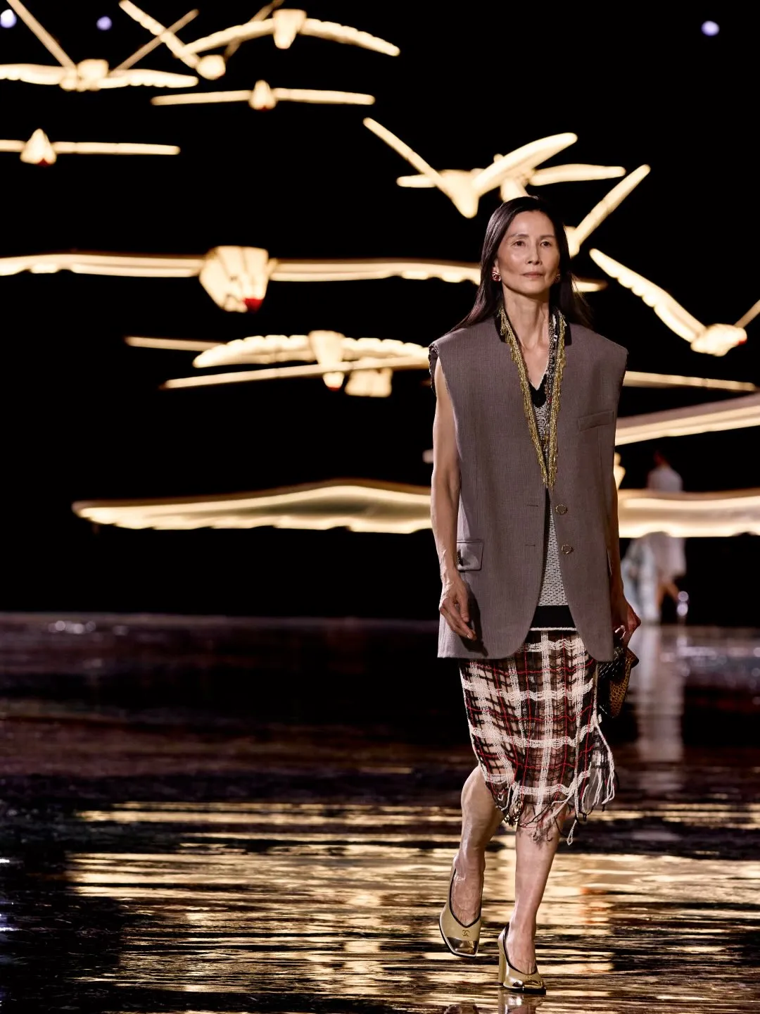 Fluid beaded dress in luminous tones exemplifying CHANEL's contemporary approach to embellishment