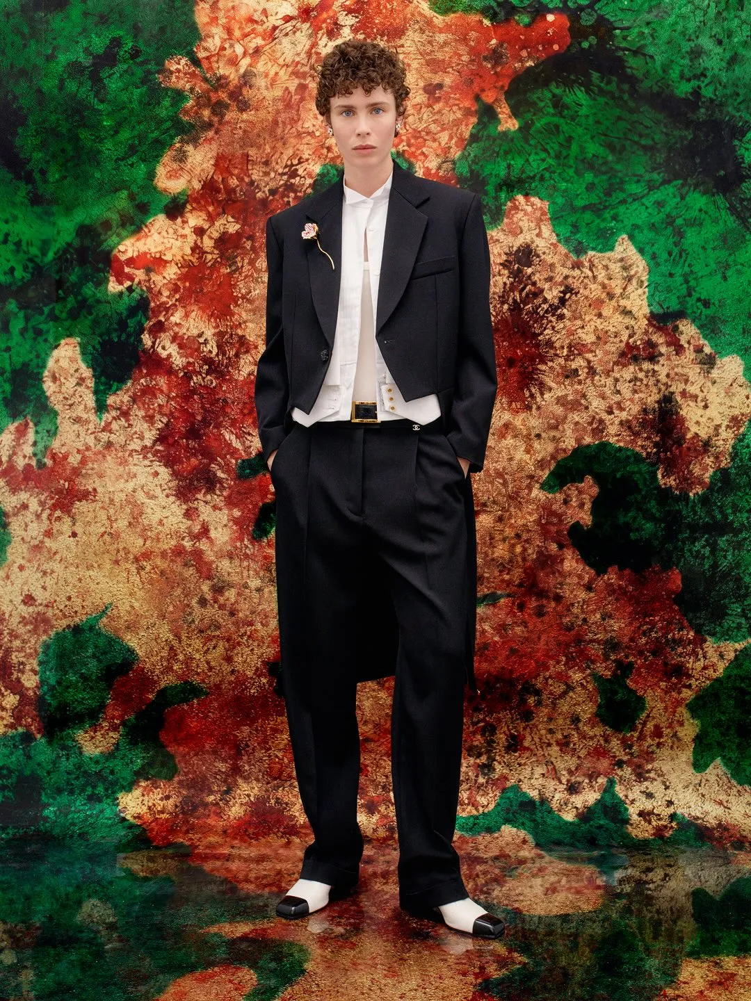 Model in elegant Chanel outfit showcasing multiple textured layers and movement