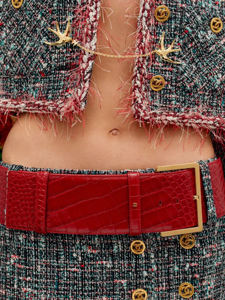Model wearing transparent overlay garment with hidden beading beneath luxurious silk