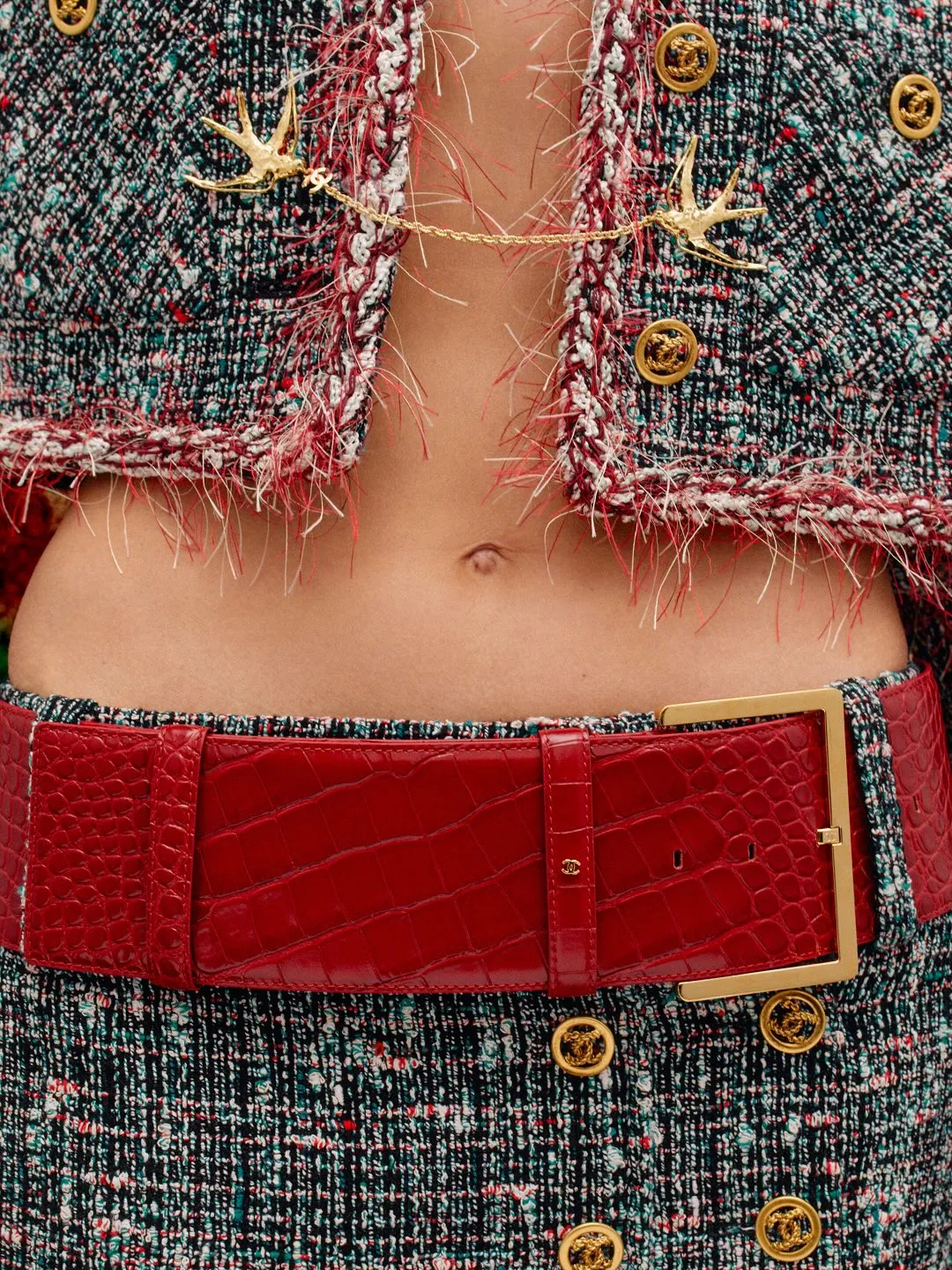 Model wearing transparent overlay garment with hidden beading beneath luxurious silk