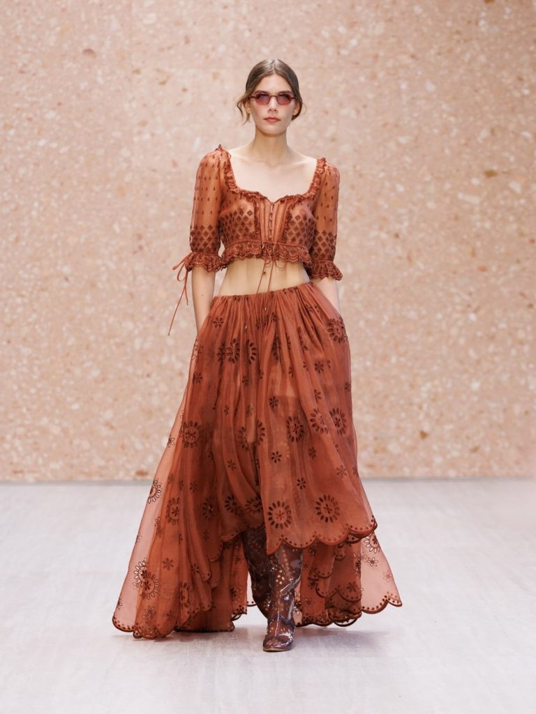 Close-up of textured terracotta linen dress with asymmetrical hemline