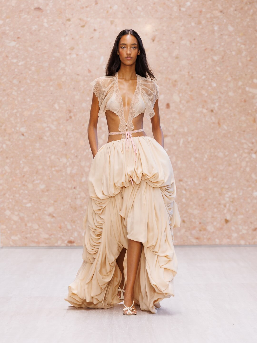 Final model wearing ultimate expression of collection in ivory and gold tones