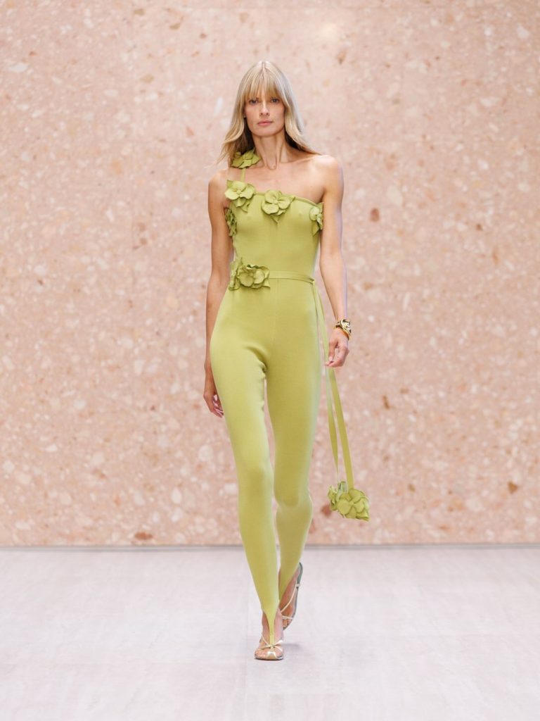 Model in honeyed gold midi dress with ethereal cape-like shoulders