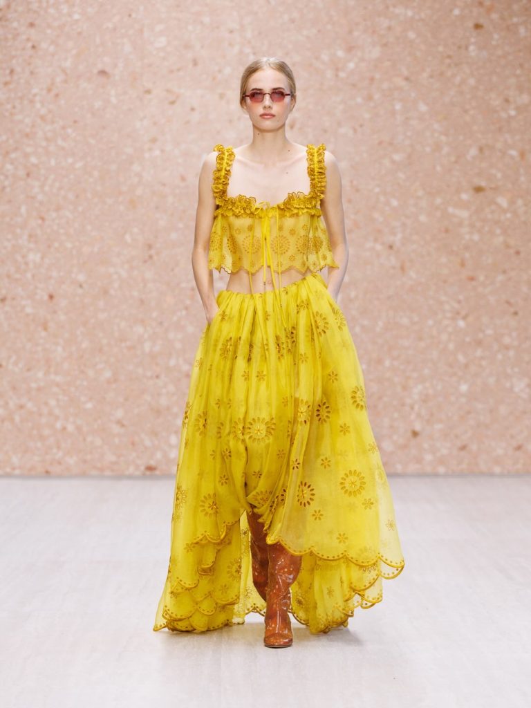 Model displaying soft peach chiffon dress with fluid movement