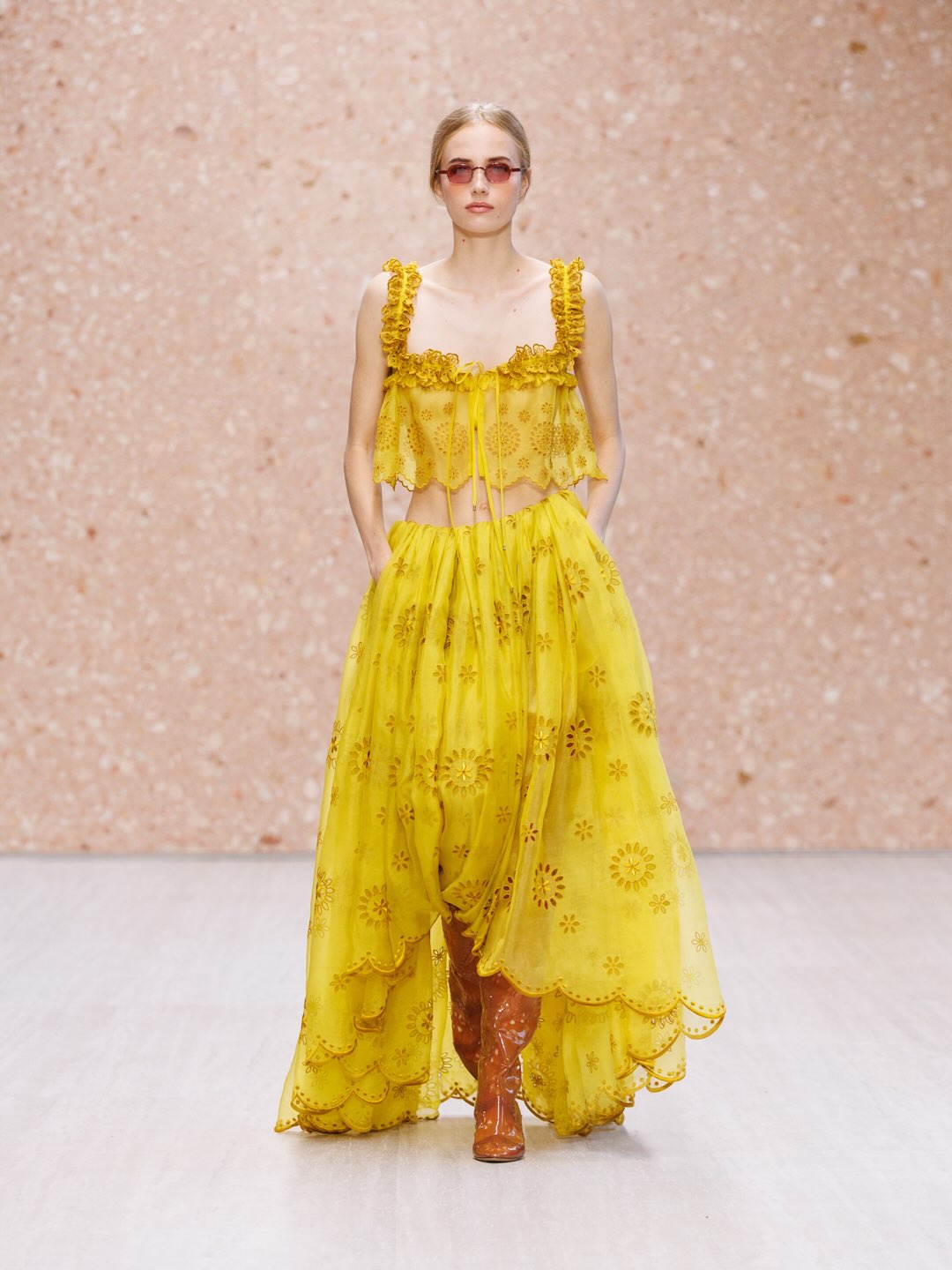 Model displaying soft peach chiffon dress with fluid movement