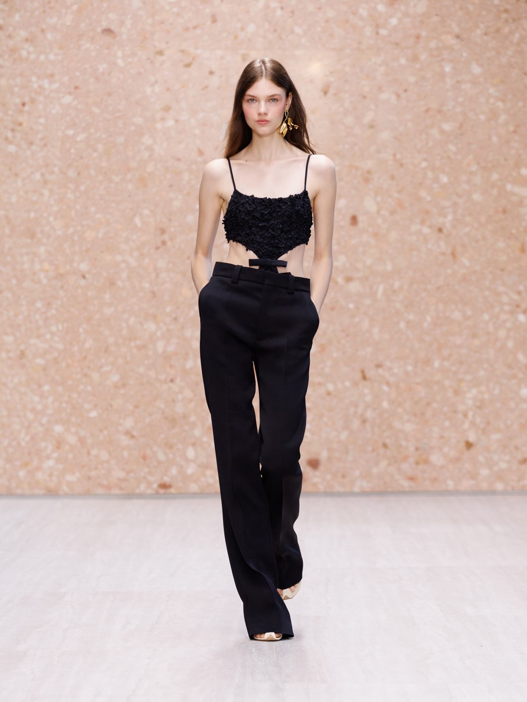Model in layered cream and ivory organdie ensemble
