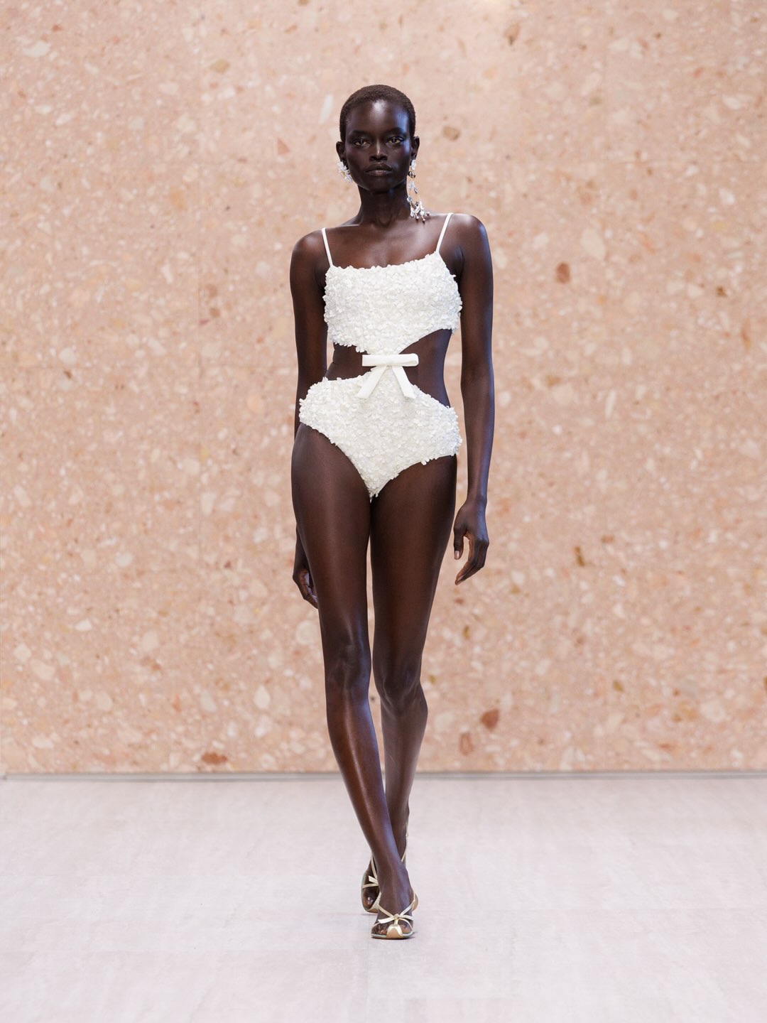 Model wearing pale rose silk slip dress with graceful back detail