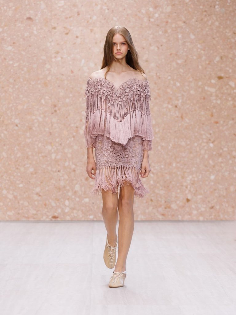 Soft pastel pink silk slip dress demonstrating fluid silhouette and luxurious drape
