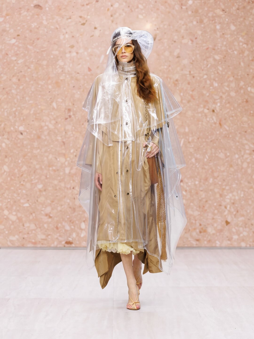 Model wearing flowing Chloé cream linen shirt with subtle draping detail