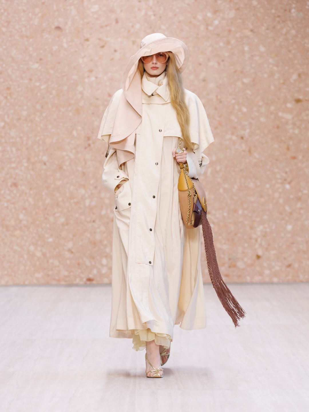 Gossamer-light fabric in pale blush creating ethereal silhouette