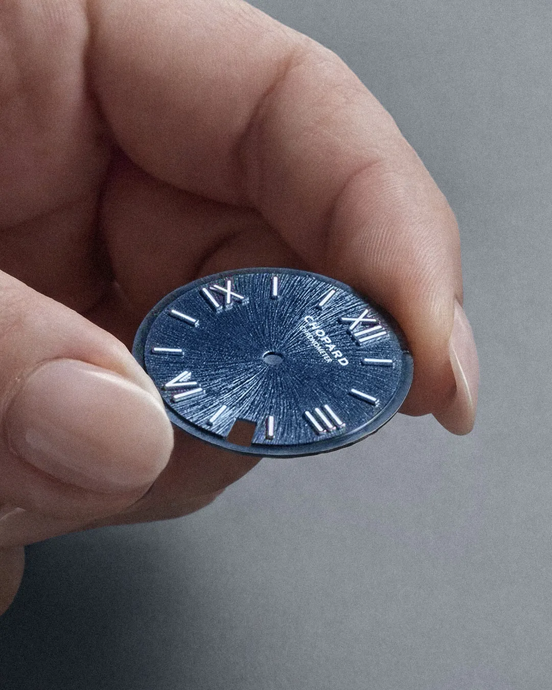 Portrait of Venera, Chopard's master dial-maker, demonstrating her sunburst dial finishing technique