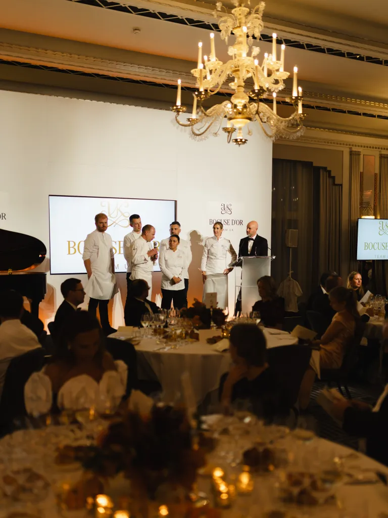 Chef in white uniform working at station during Bocuse d'Or preparation at Claridge's