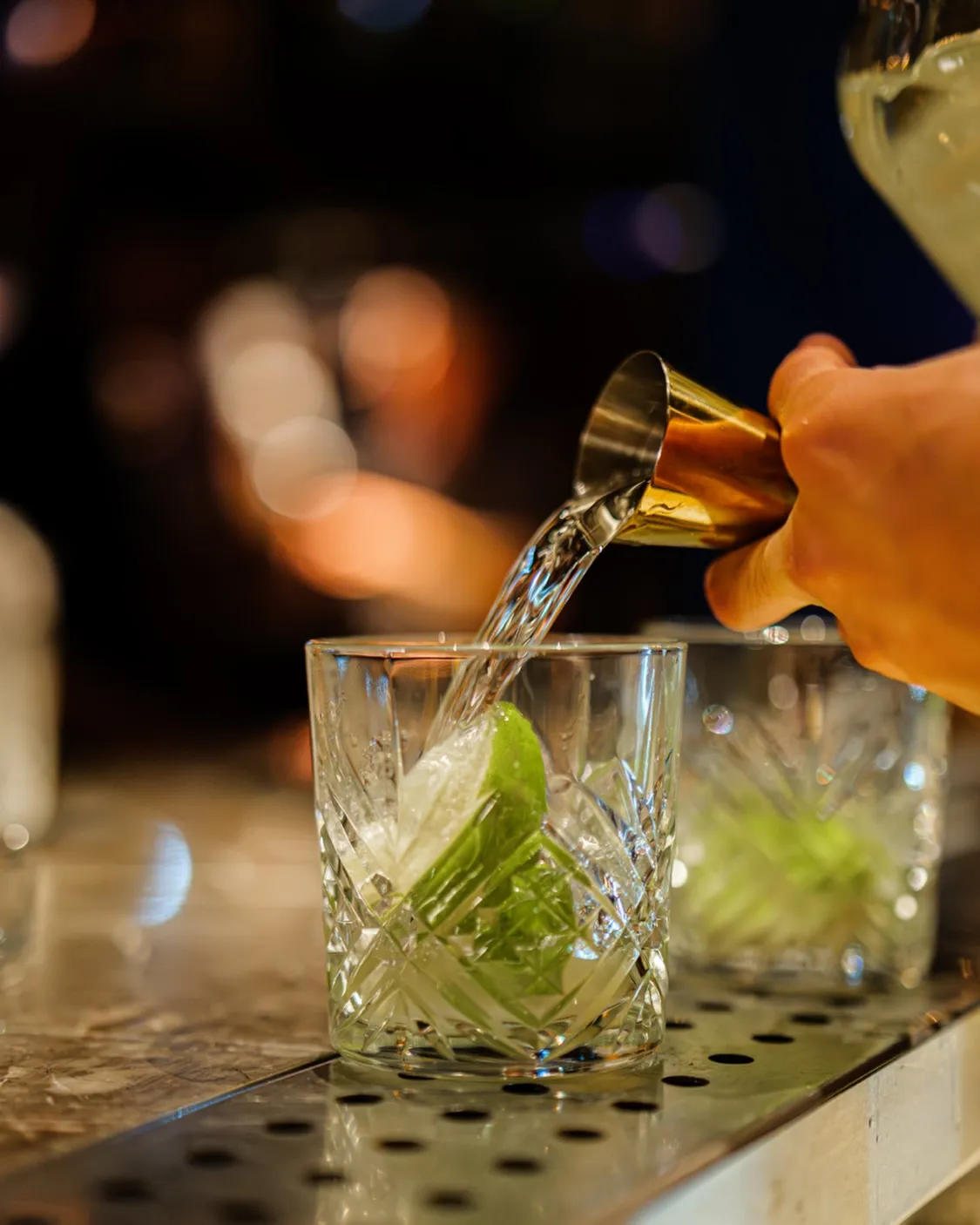 A precisely crafted cocktail being prepared at Coya Monte Carlo, exemplifying refined bartending technique and artisanal cocktail craftsmanship