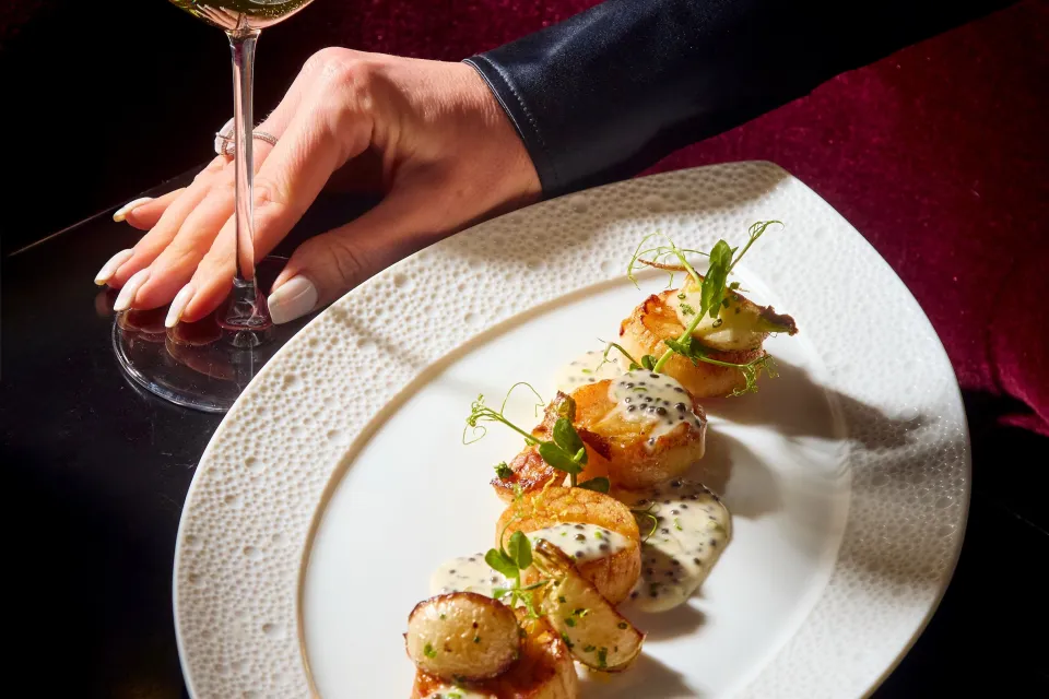 Elegantly plated fresh-caught seafood at CUT Beverly Hills showcasing delicate textures and seasonal coastal accents