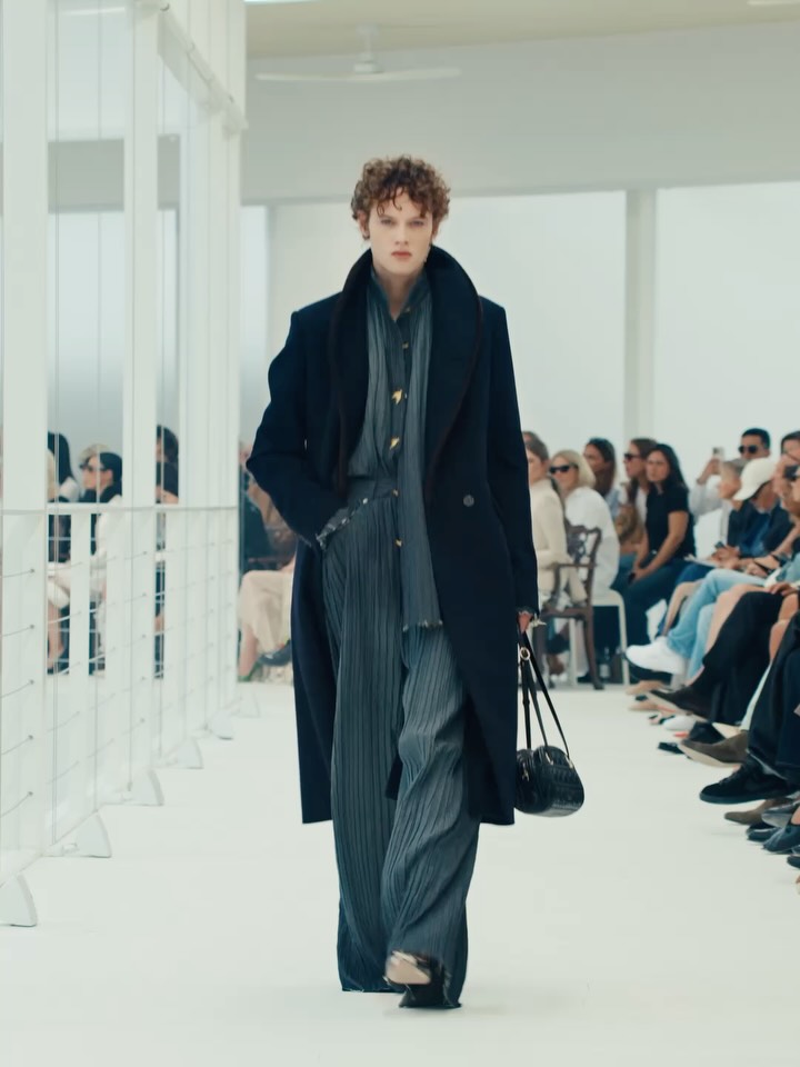 Model walking runway in refined neutral tones with jewelled accents