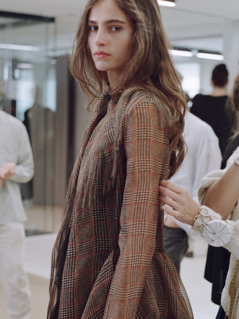 Model wearing reimagined Cocotte dress in refined neutral palette