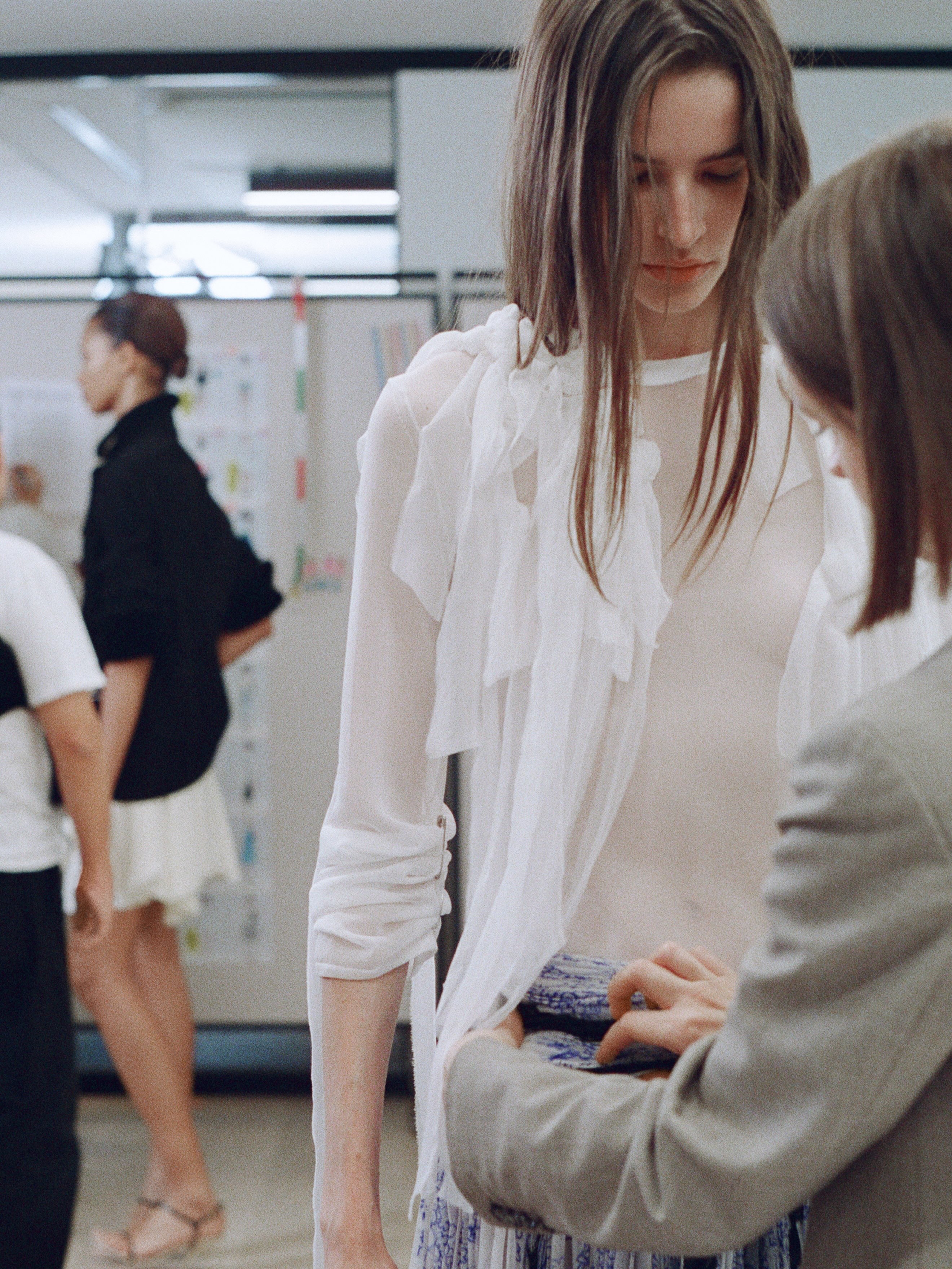 Hair styling by Guido Palau creating sculptural elegance backstage