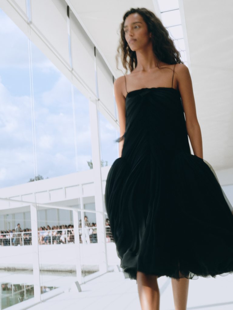 Close detail of intricate hand-pleated chiffon construction catching light