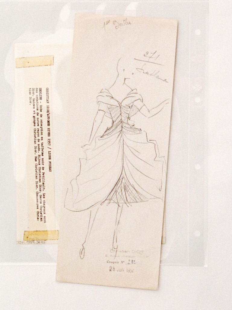 Model in profile showcasing the flowing movement of pleated chiffon layers