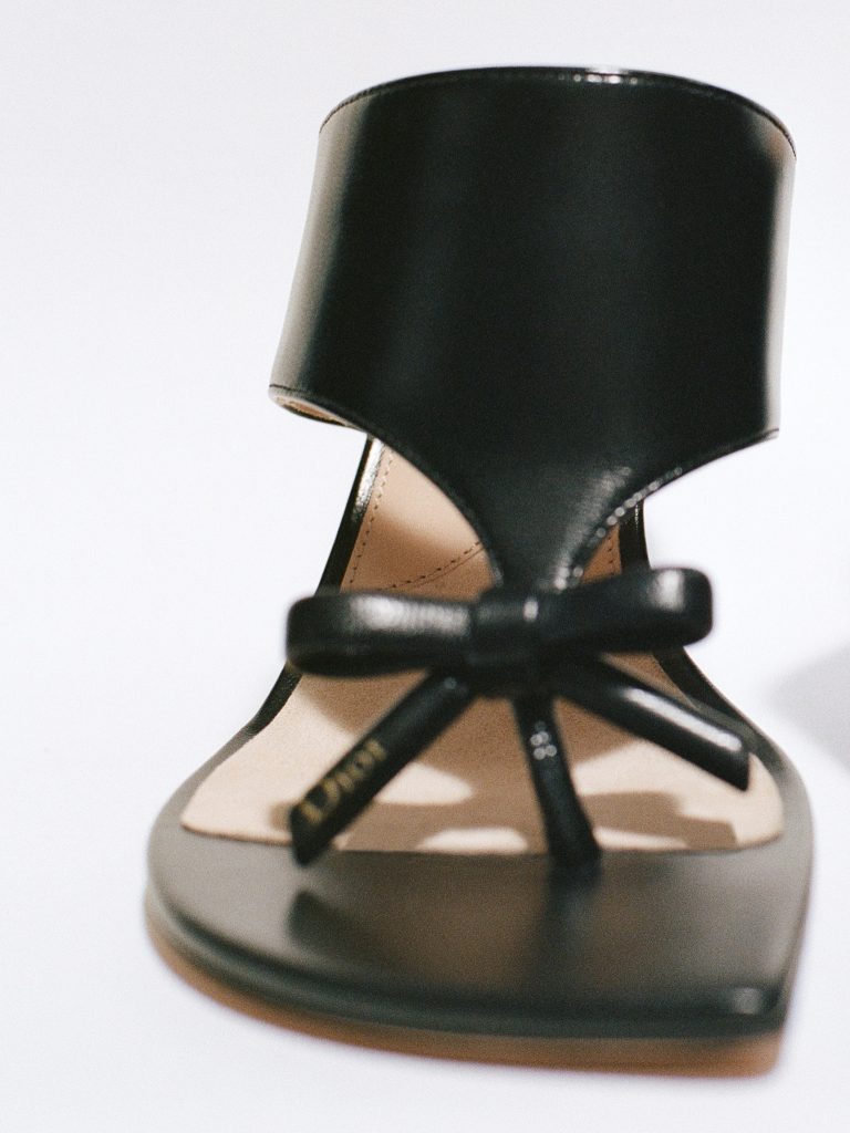 A model in a precisely tailored Dior summer ensemble showcasing refined proportions