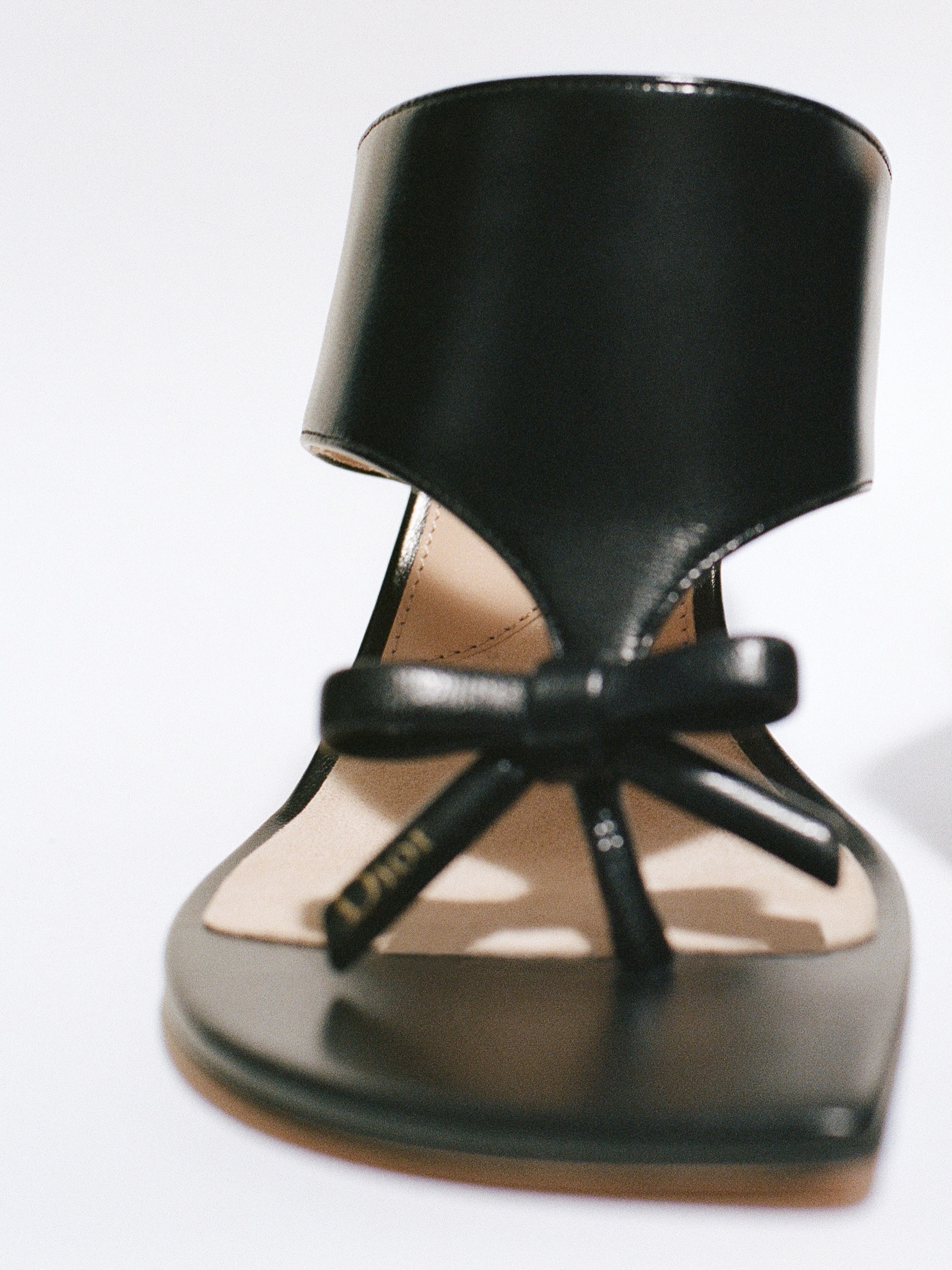 A model in a precisely tailored Dior summer ensemble showcasing refined proportions
