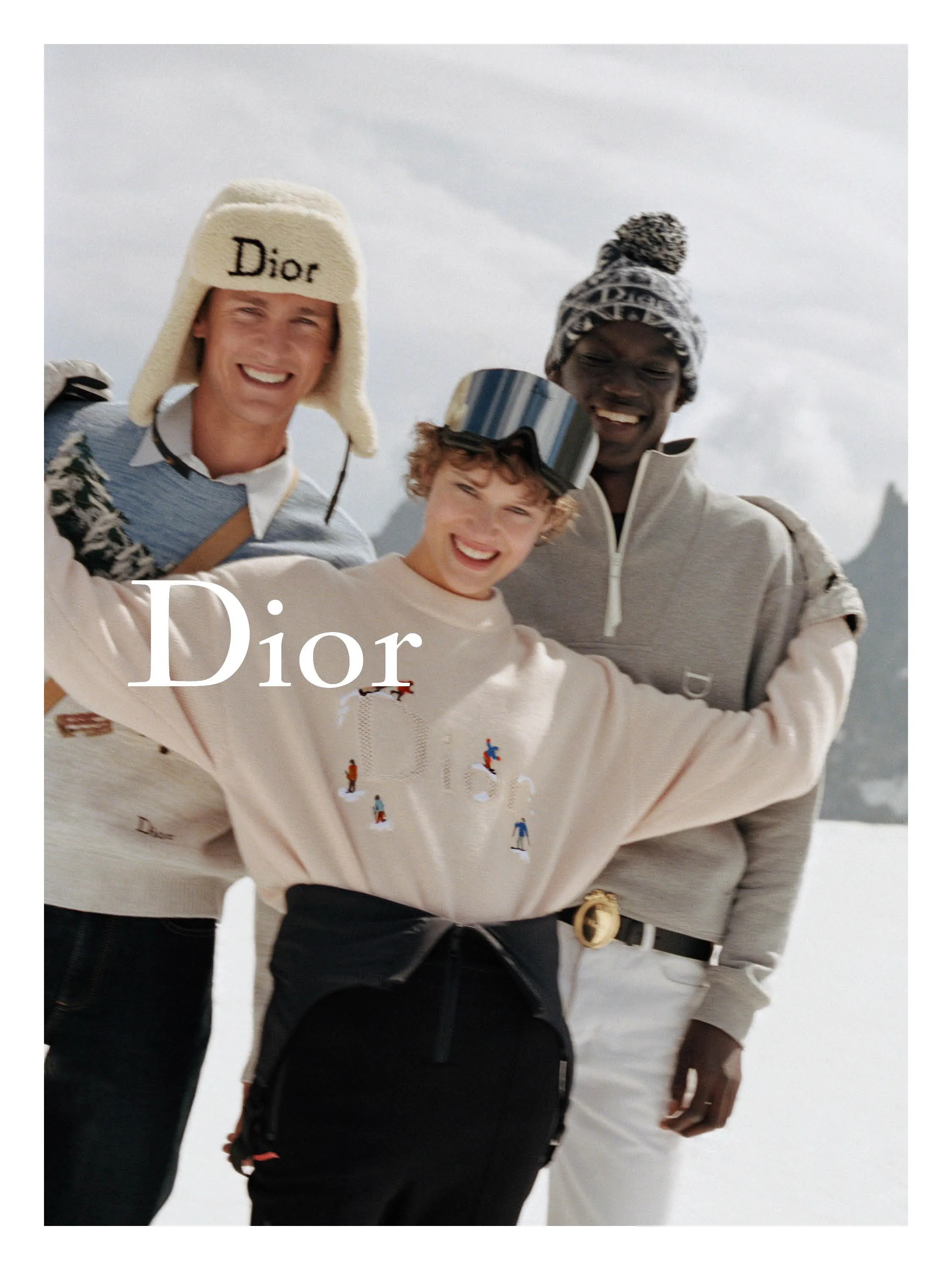 Male model wearing Dior Alps navy ski jacket and fitted snow trousers, photographed against minimalist white studio backdrop