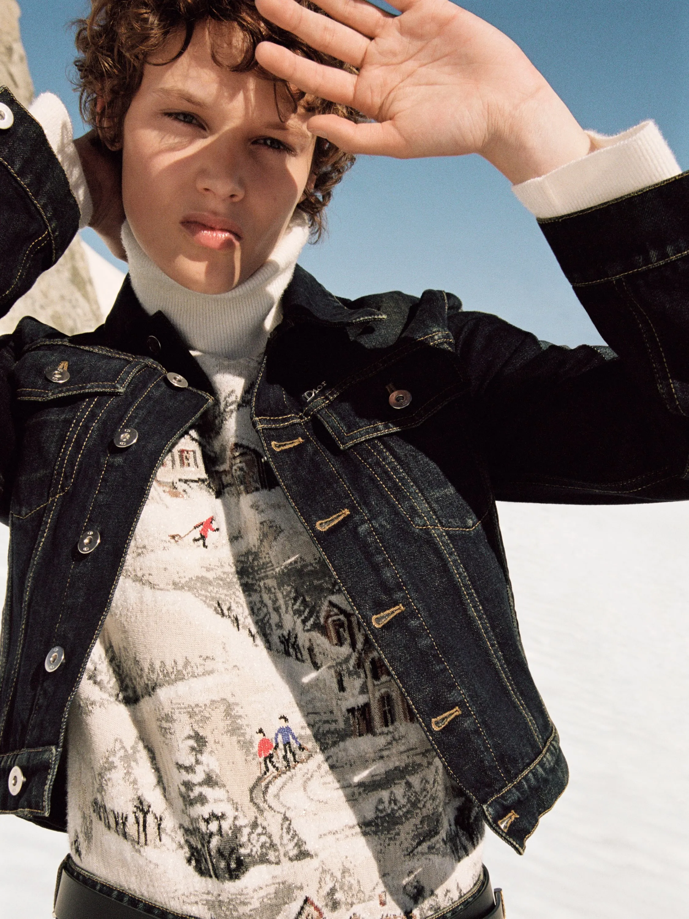 Female model in cream-toned Dior Alps ski ensemble with coordinating base layers, posed with serene alpine aesthetic