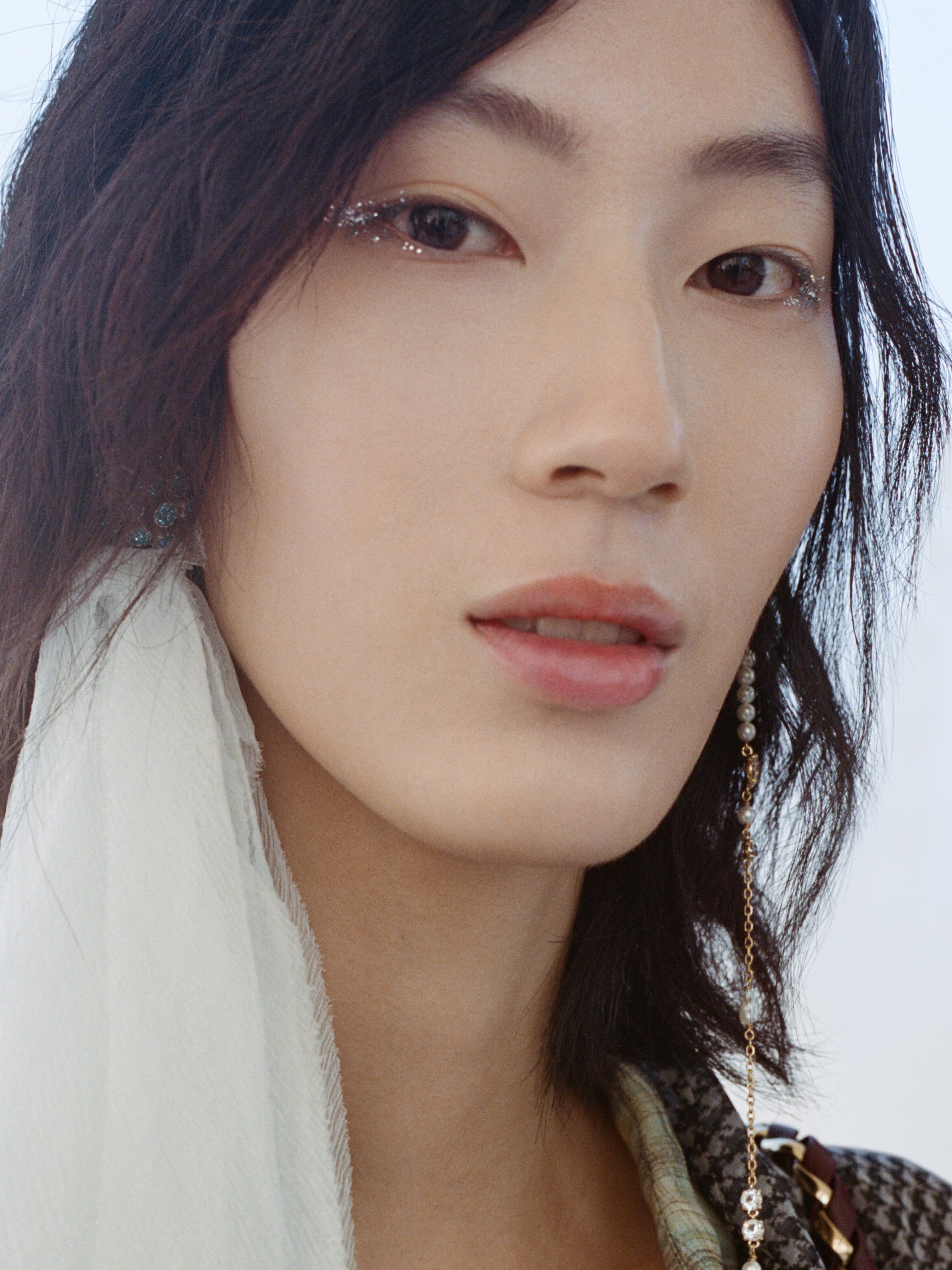 Beauty close-up highlighting the glossy lip and brow coordination