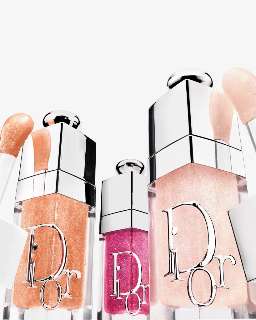 Dior Addict Lip Glow and Dior Addict Lip Glow Oil limited edition tubes arranged to showcase their luminous finishes and festive packaging