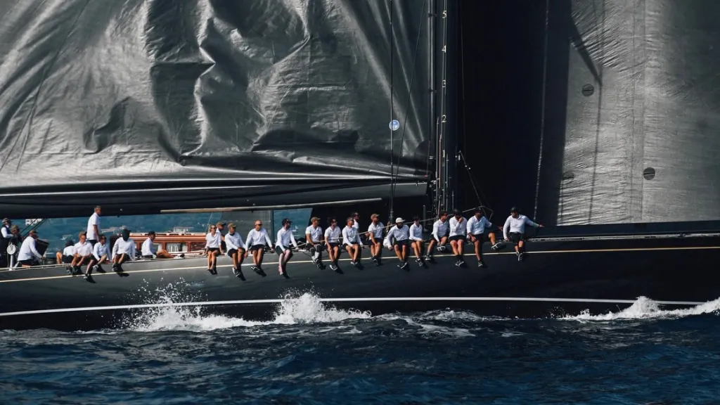 A Maxi yacht heeling dramatically as it accelerates through the Voiles de Saint-Tropez course