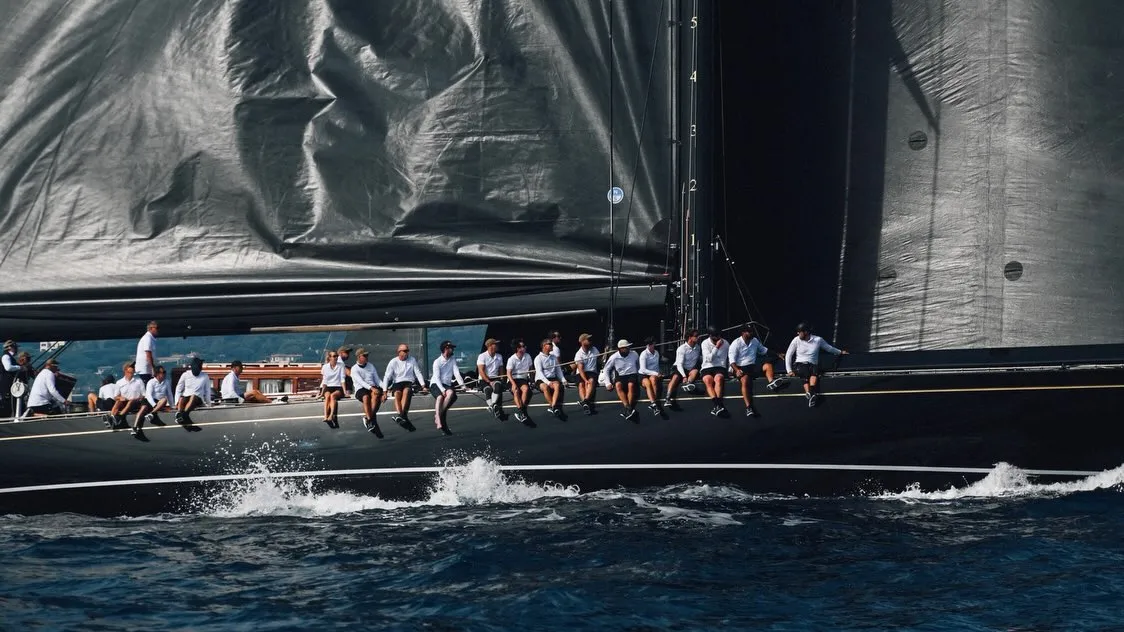 A Maxi yacht heeling dramatically as it accelerates through the Voiles de Saint-Tropez course