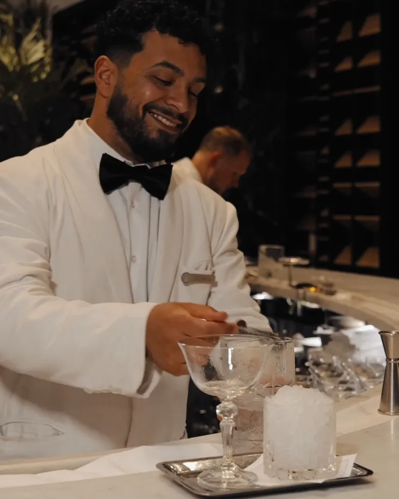 Bartender carefully stirring the signature Chandelier Martini with precision and care at the Chandelier Bar