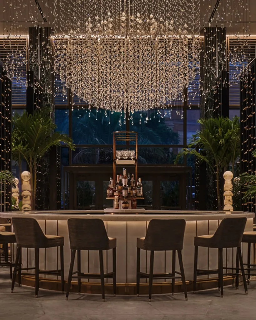 Bottles of Herbsaint and premium spirits used in crafting the Four Seasons signature cocktail