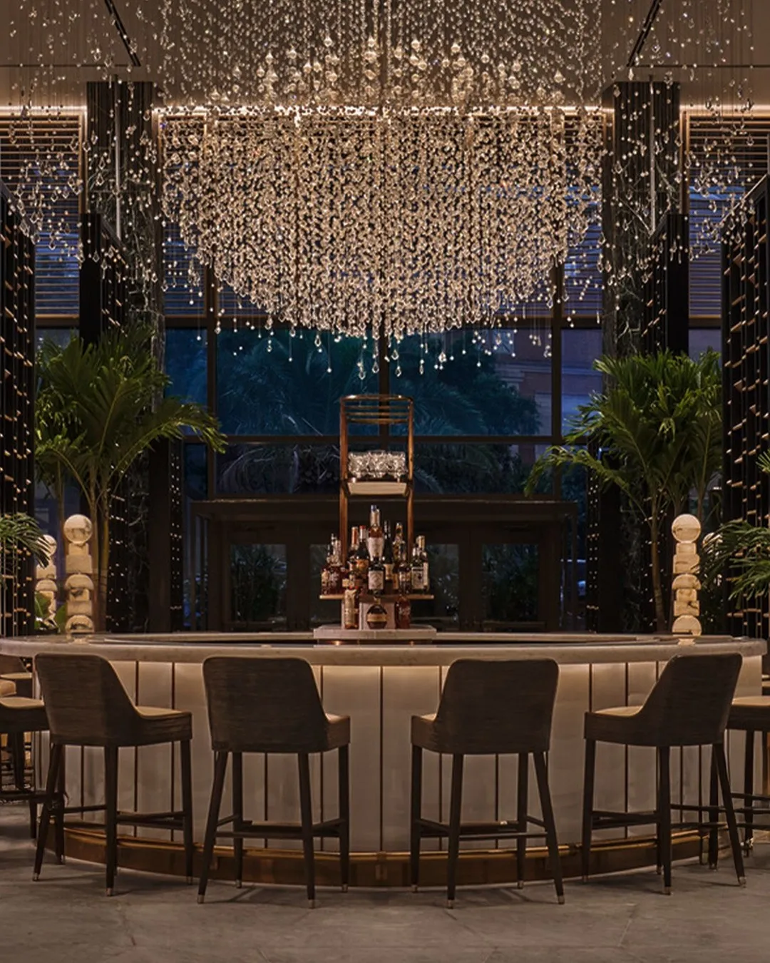 Bottles of Herbsaint and premium spirits used in crafting the Four Seasons signature cocktail