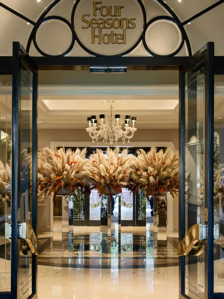 Jeff Leatham's autumn floral installation at Four Seasons Los Angeles featuring layered natural textures and rich fall colours in the arrival lobby