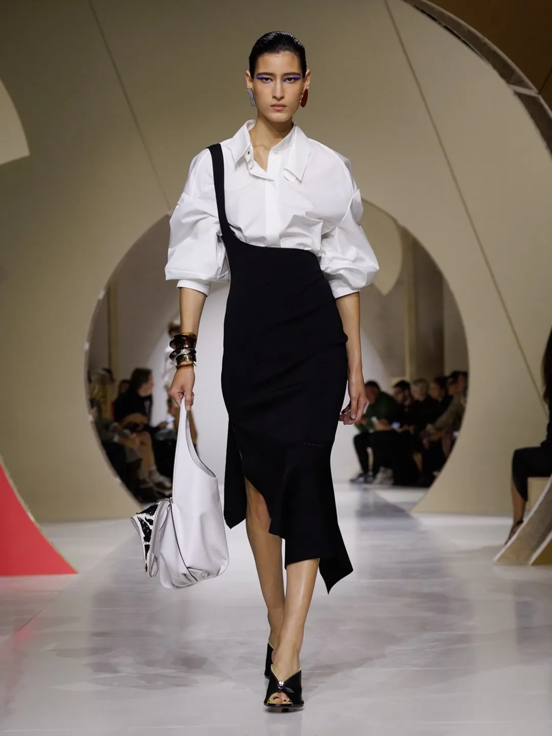 Full look from the collection featuring simplified silhouette and luminous neutral palette reflecting the season's aesthetic