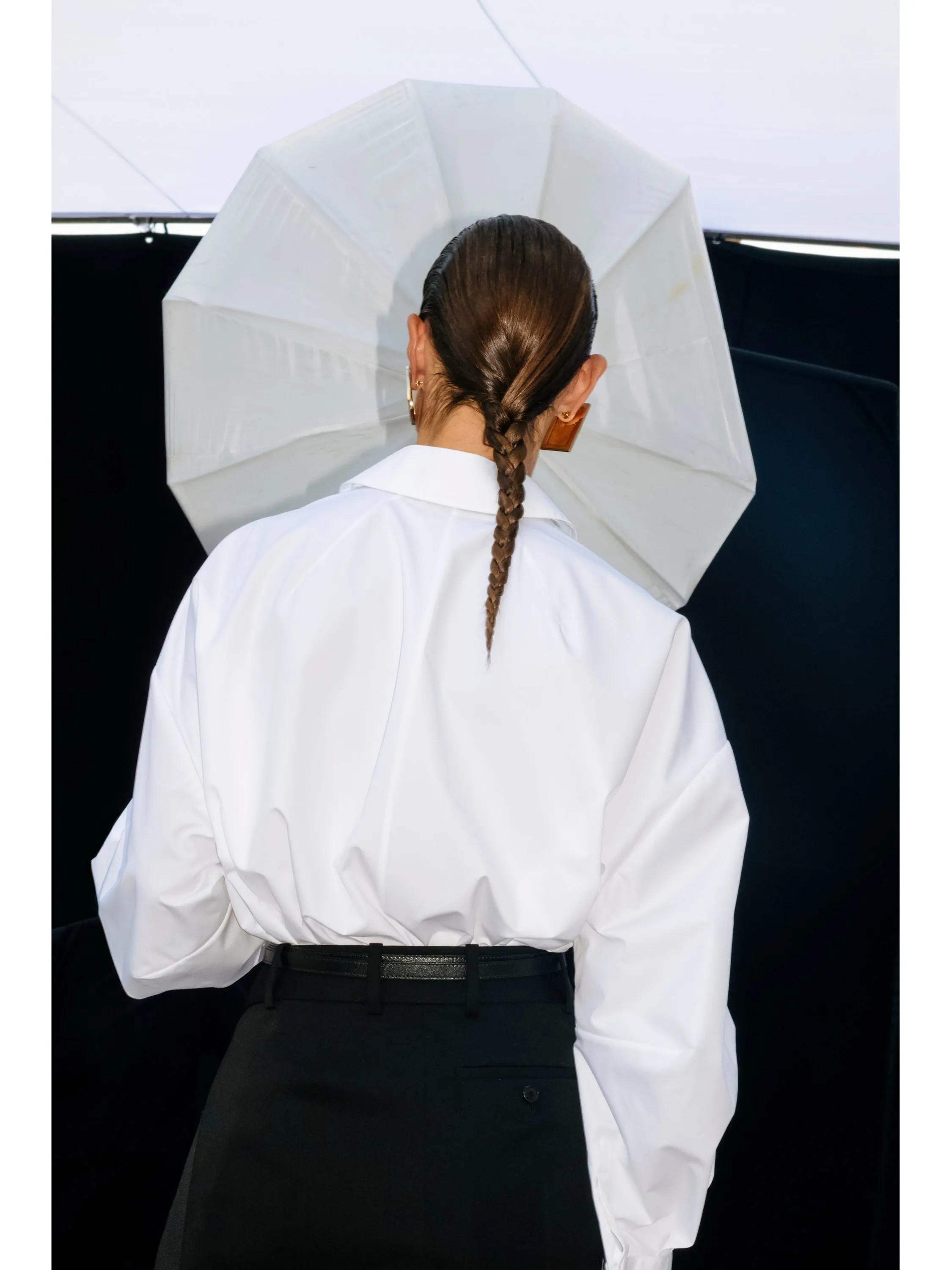 Soft neutral column silhouette with architectural cut-out detailing at shoulder