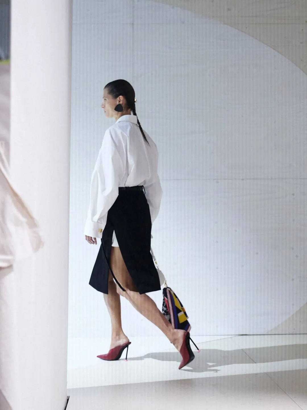 Cream-coloured dress featuring strategic asymmetry and subtle cut-out detail