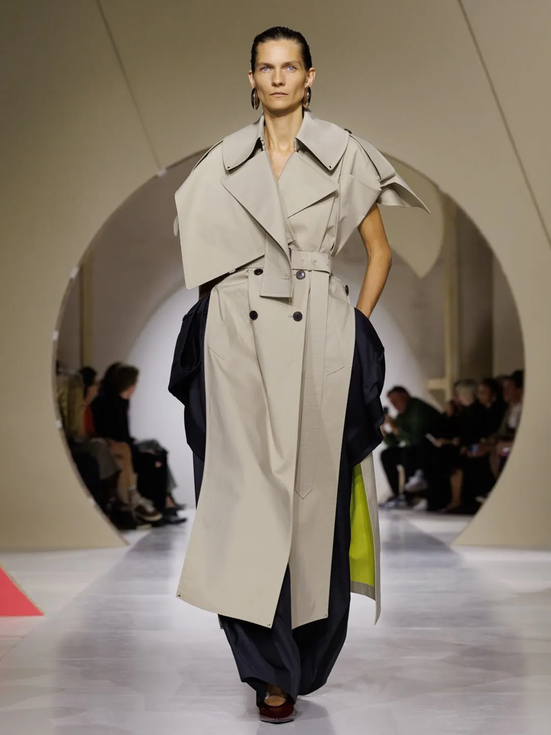 Detail of geometric slash cuts on a structured Givenchy gabardine trench
