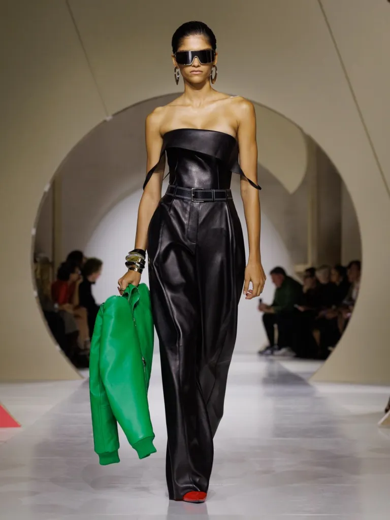 Model Lily in structured black leather midi dress with architectural silhouette