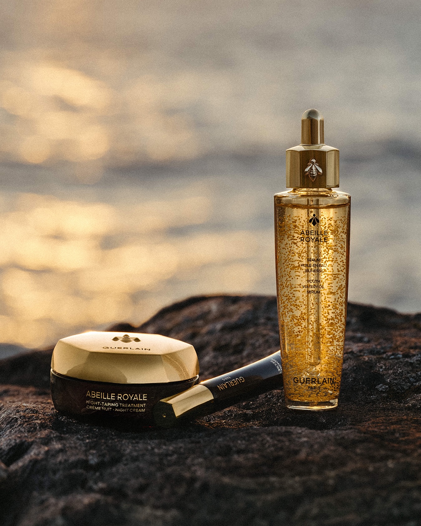 Guerlain Abeille Royale Youth Serum and Night-Taping Treatment skincare collection displayed with honey-infused formulations