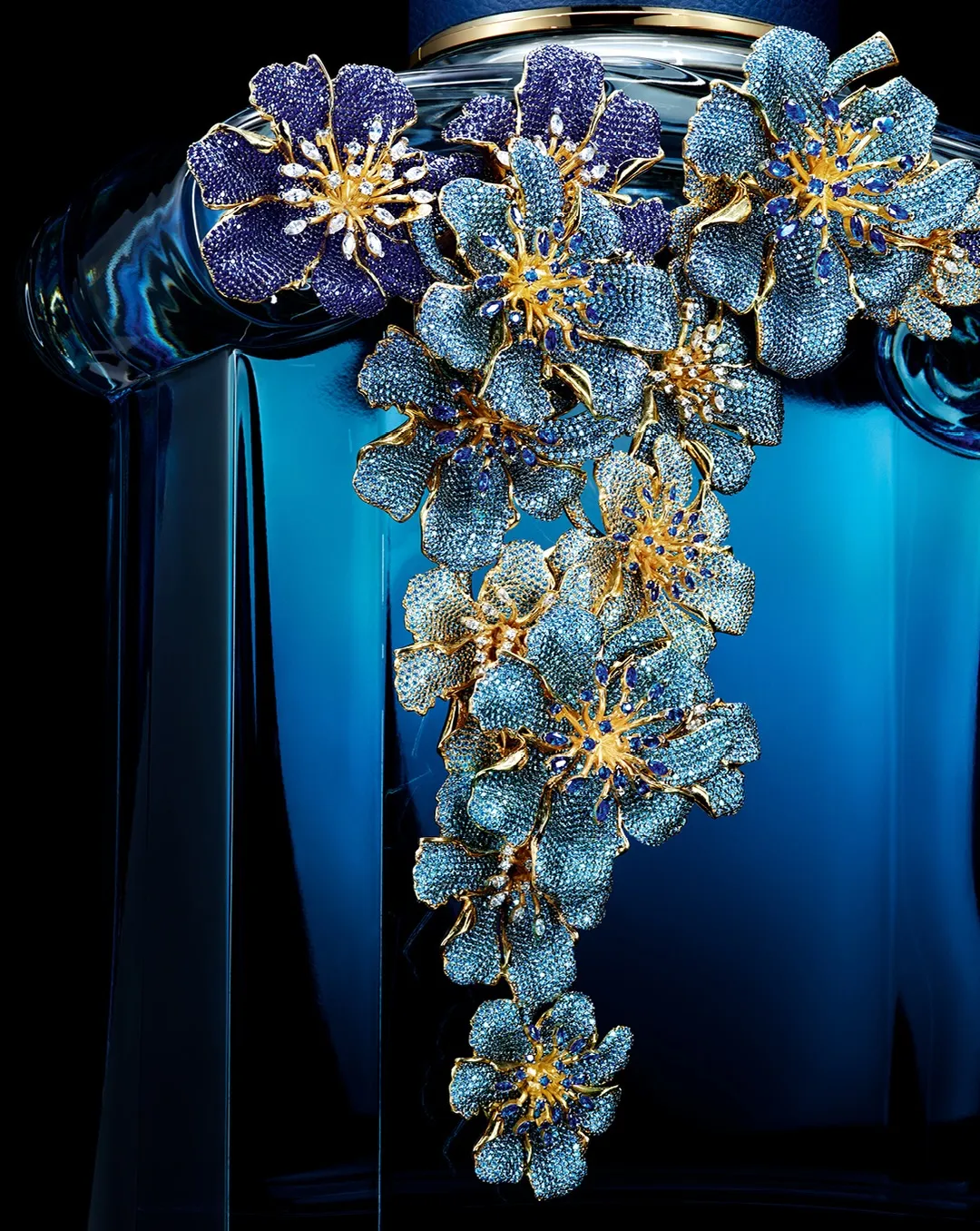 Cascading blue flowers adorned with thousands of sparkling gems set in gold-plated bronze