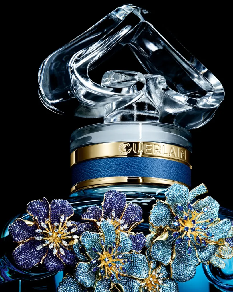 Close detail of hand-set gemstones in shades of blue creating luminous patterns across the floral composition