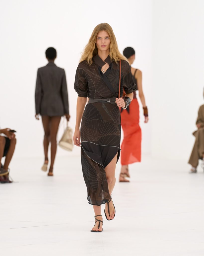 Soft terracotta accent piece showcasing fabric movement and architectural design elements