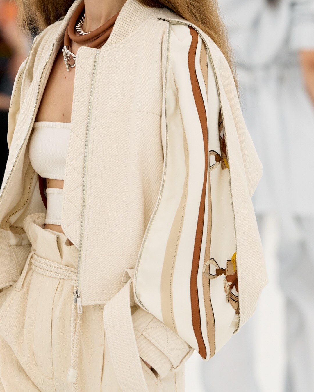 Full-length view of draped spring-summer piece demonstrating movement and silhouette