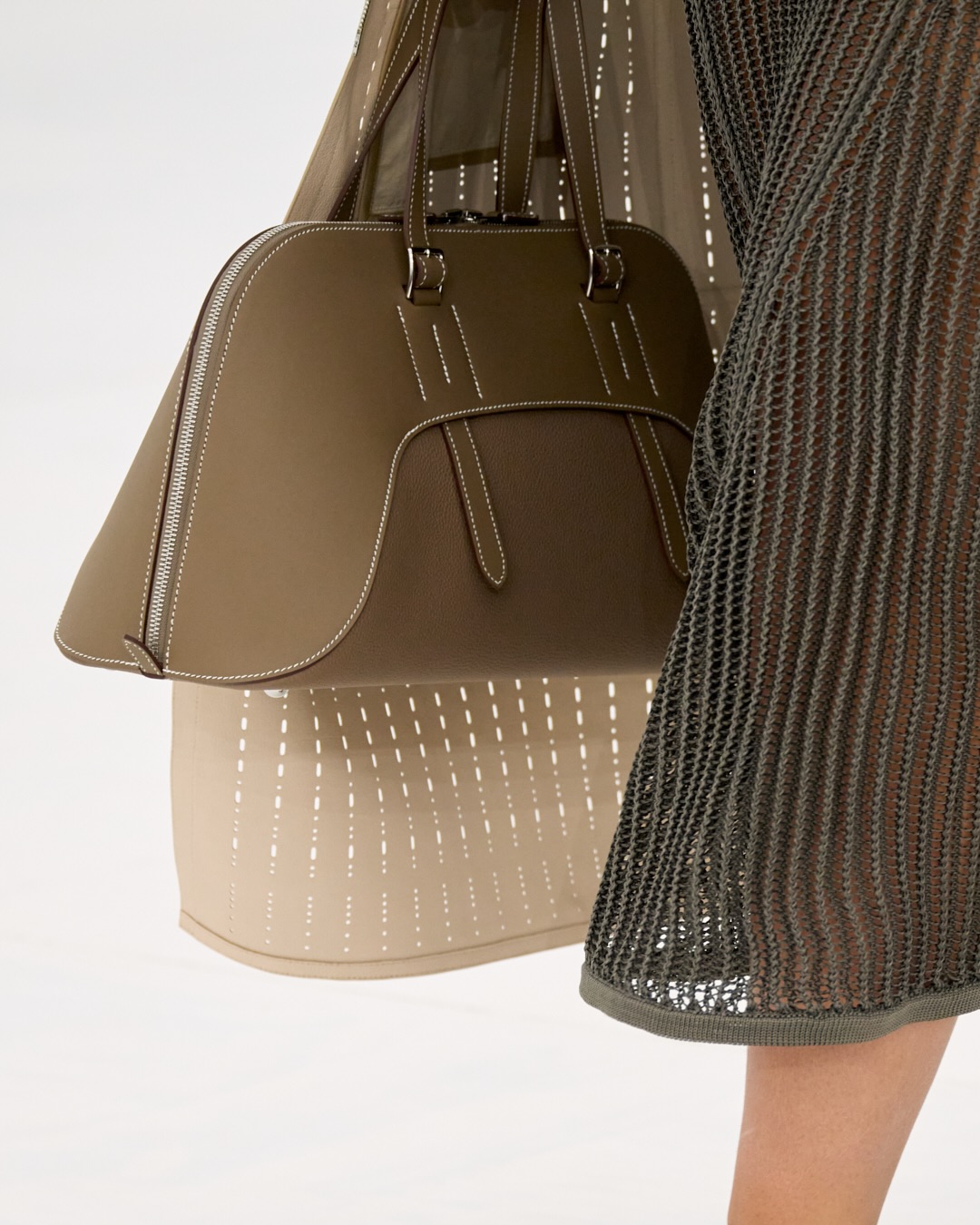 Model in minimalist neutral tones showcasing the collection's understated elegance