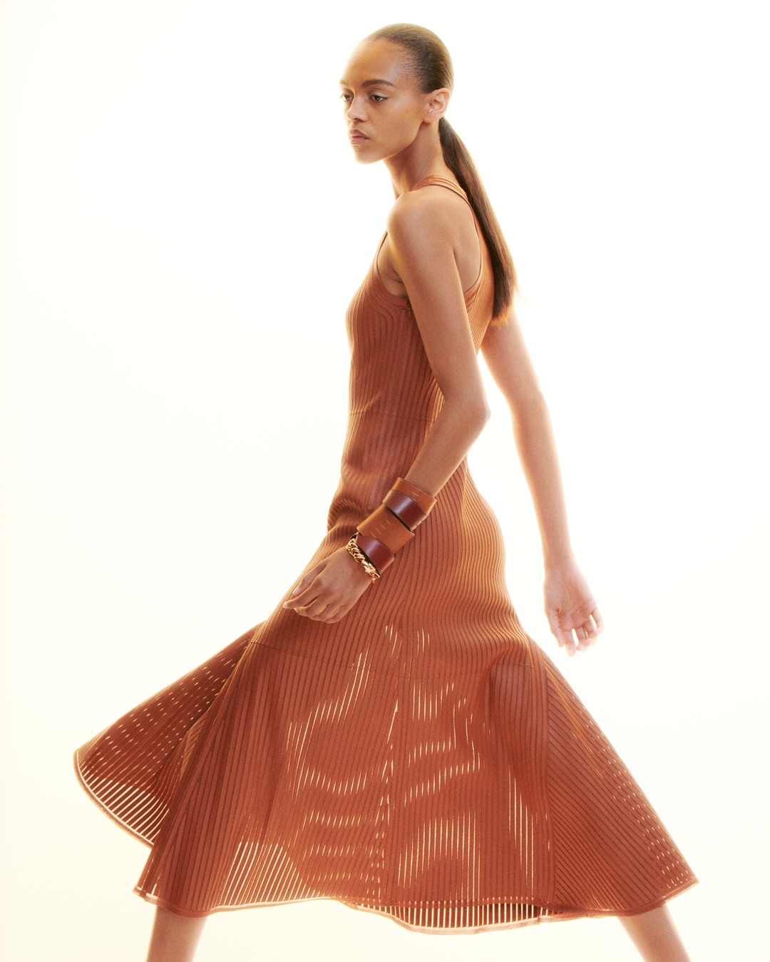 Model wearing structured linen garment with lifted hem, spring-summer 2027 collection